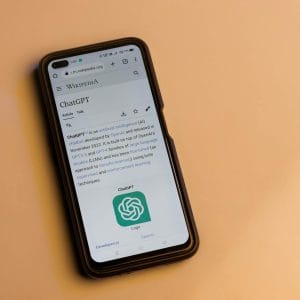 A smartphone displaying the Wikipedia page for ChatGPT, illustrating its technology interface.