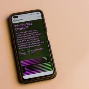 Smartphone screen showing ChatGPT introduction by OpenAI, showcasing AI technology.